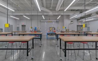 Buena Vista High School classroom interior with high tables, stools and hanging electrical outlets