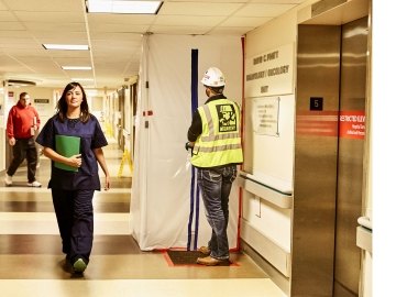 Person working inside of a hospital and a nurse. 
