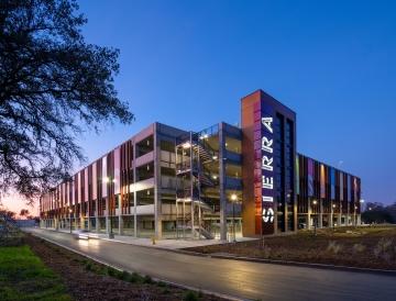 A parking structure at dusk. 