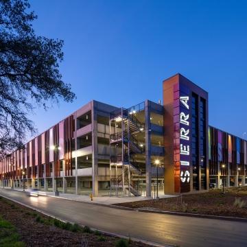 A parking structure at dusk. 