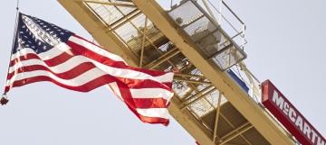 flag waving in front of a crane