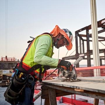 A person using a circular saw