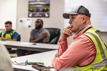 person sitting in construction meeting
