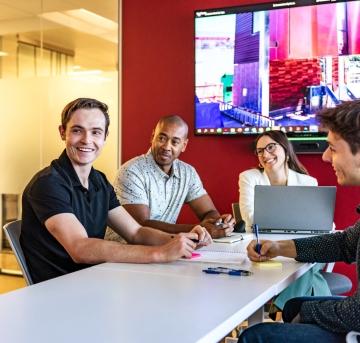 people sitting in office space around a table