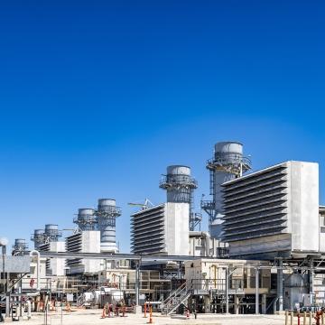 View down a row of five generators at a combined cycle power plant