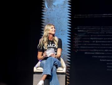 A person sitting in a chair on a stage