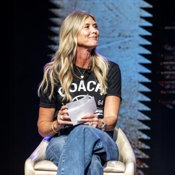 A person sitting in a chair on a stage