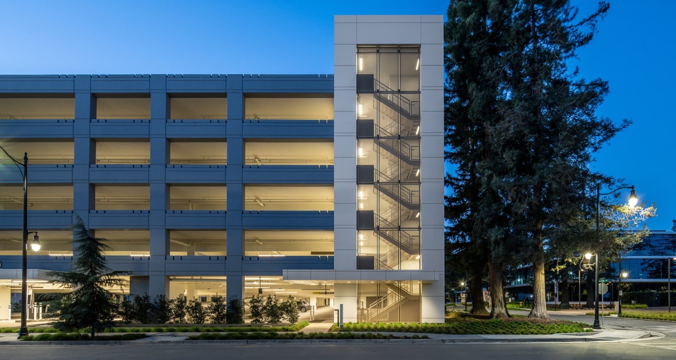 Exterior view of parking garage at night.