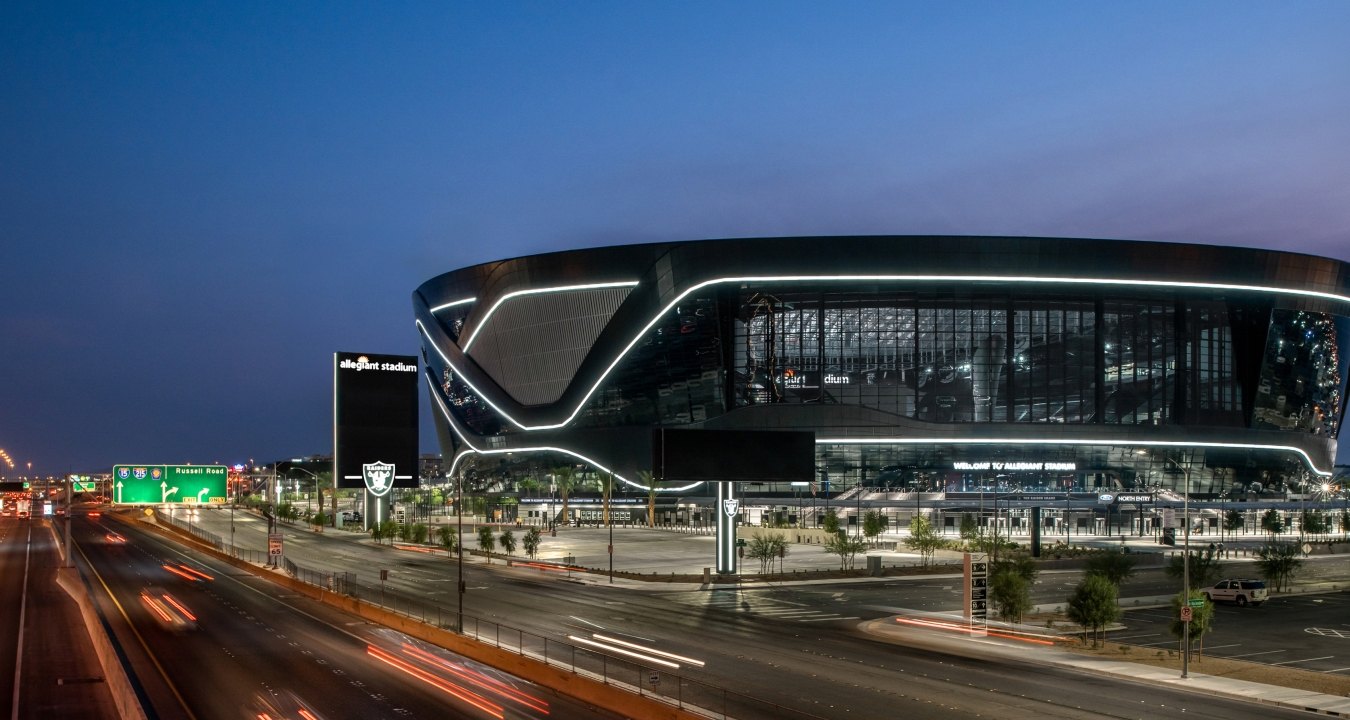 Aerial view of the stadium at night, with the highway in front