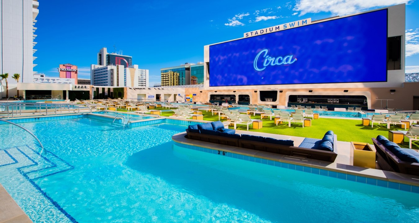 Rooftop swimming pool with a large screen reading "Circa"