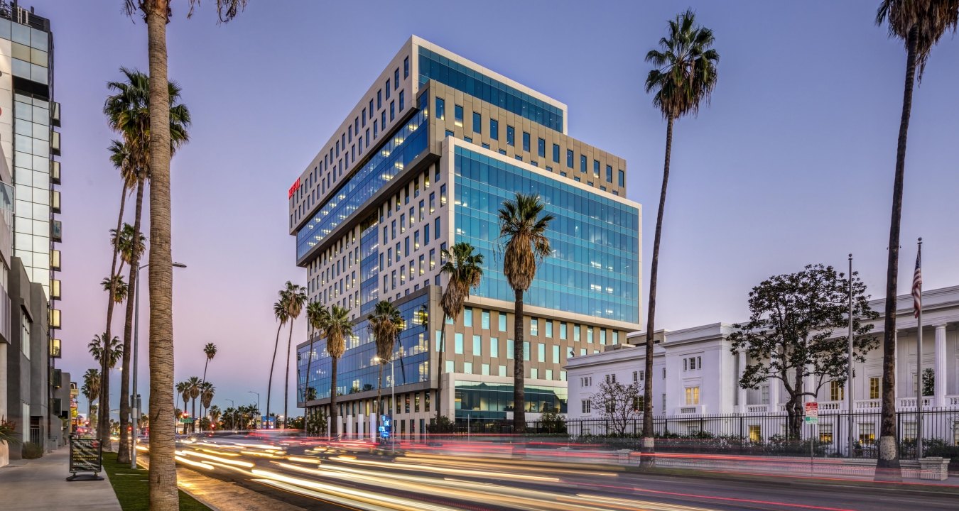 Sunset Bronson Studios ICON Office Tower with surrounding buildings, roadway and palm trees