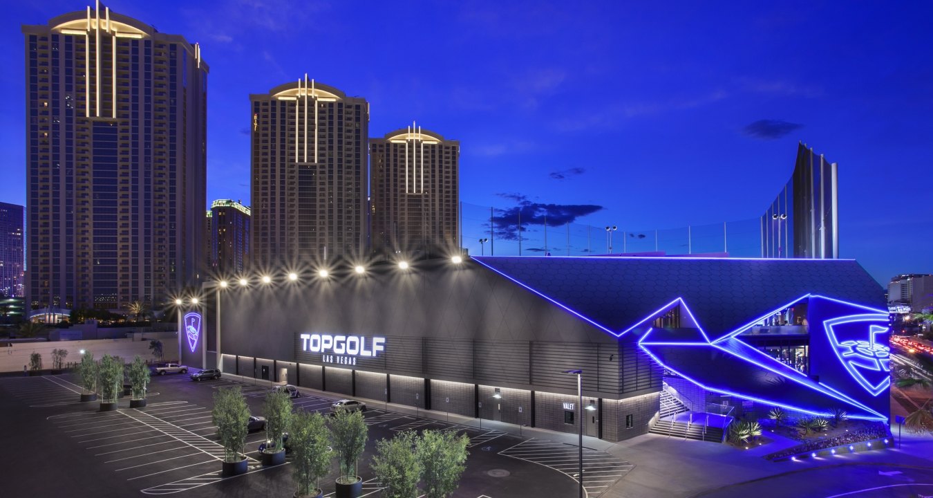 Exterior view of the Topgolf building at nighttime