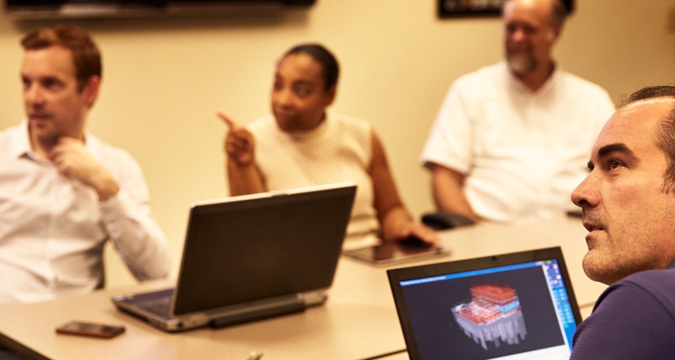 People having a meeting in a conference room.