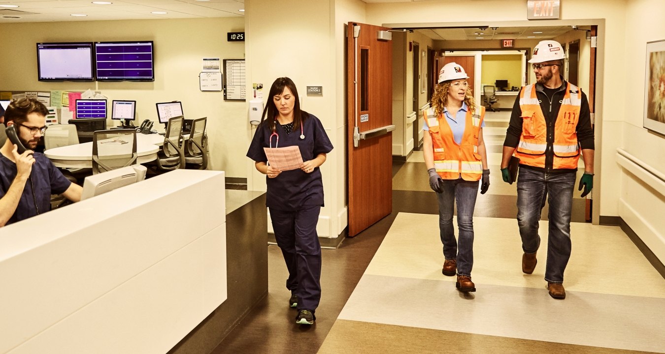 Construction workers and medical staff in a hospital.