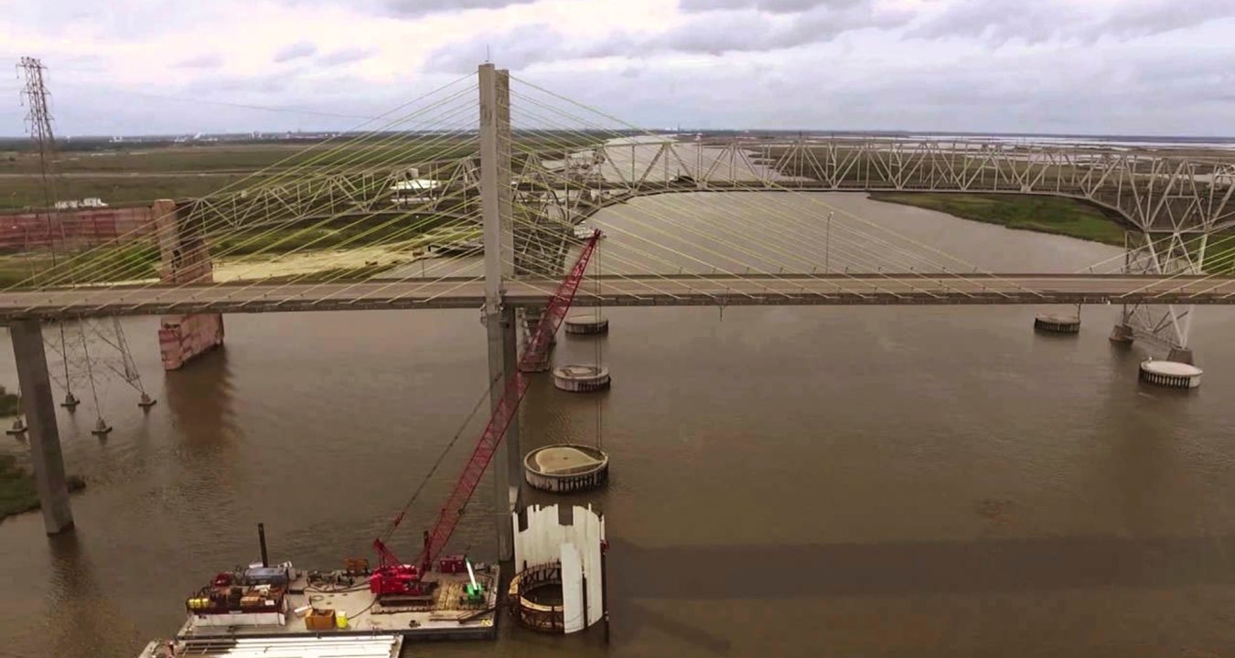 A crane on a barge in the water during construction