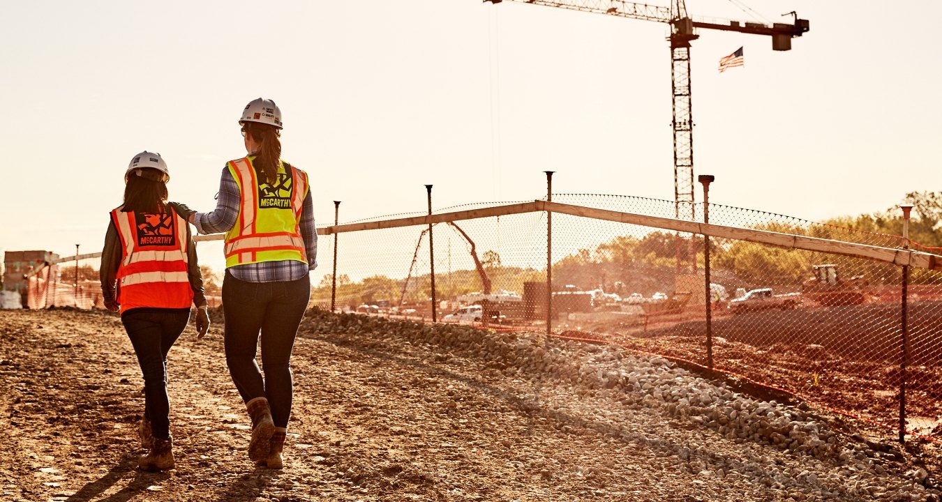 Construction workers walking around a jobsite.