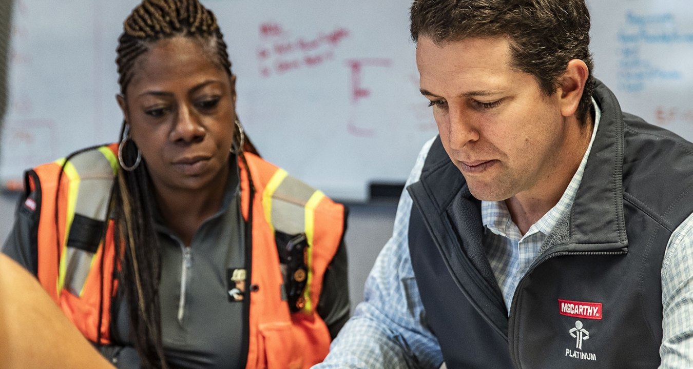 3 people looking over construction plans.