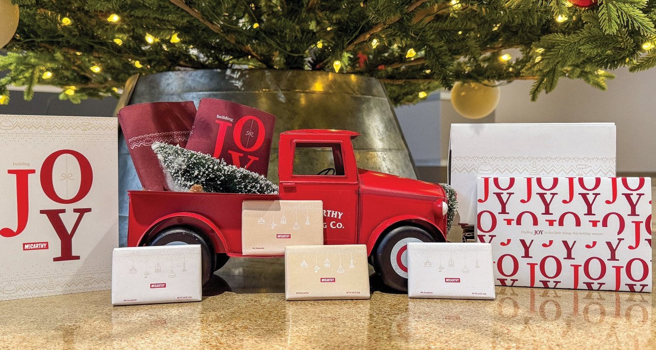 Various McCarthy-branded holiday elements under the Christmas tree.