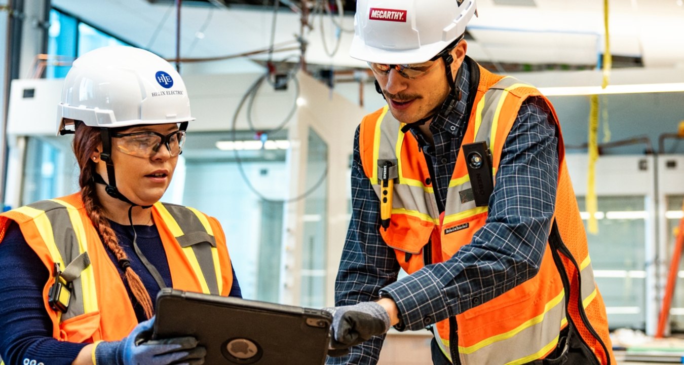 Two people working at a jobsite
