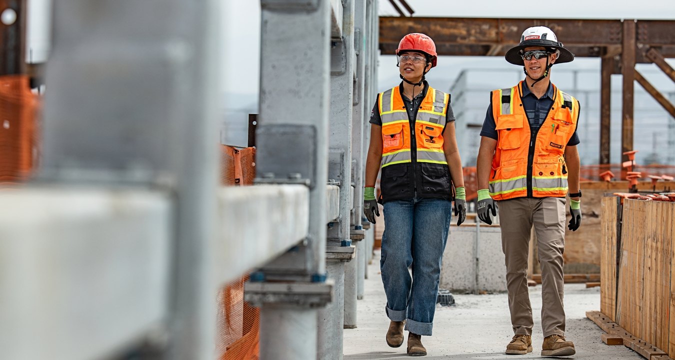 Two people walking a jobsite