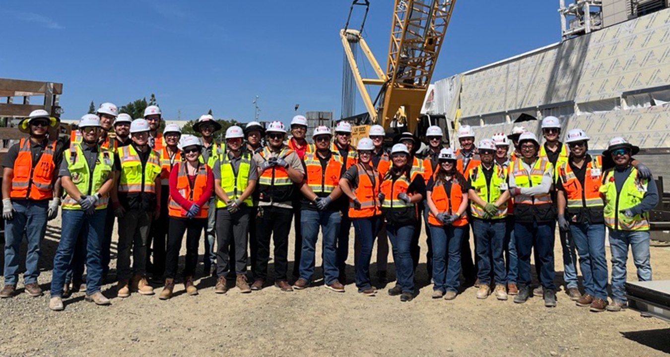 Group of people wearing PPE standing at a jobsite