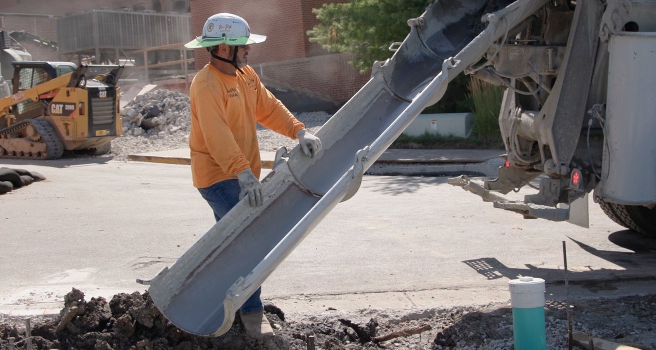 A person pouring concrete