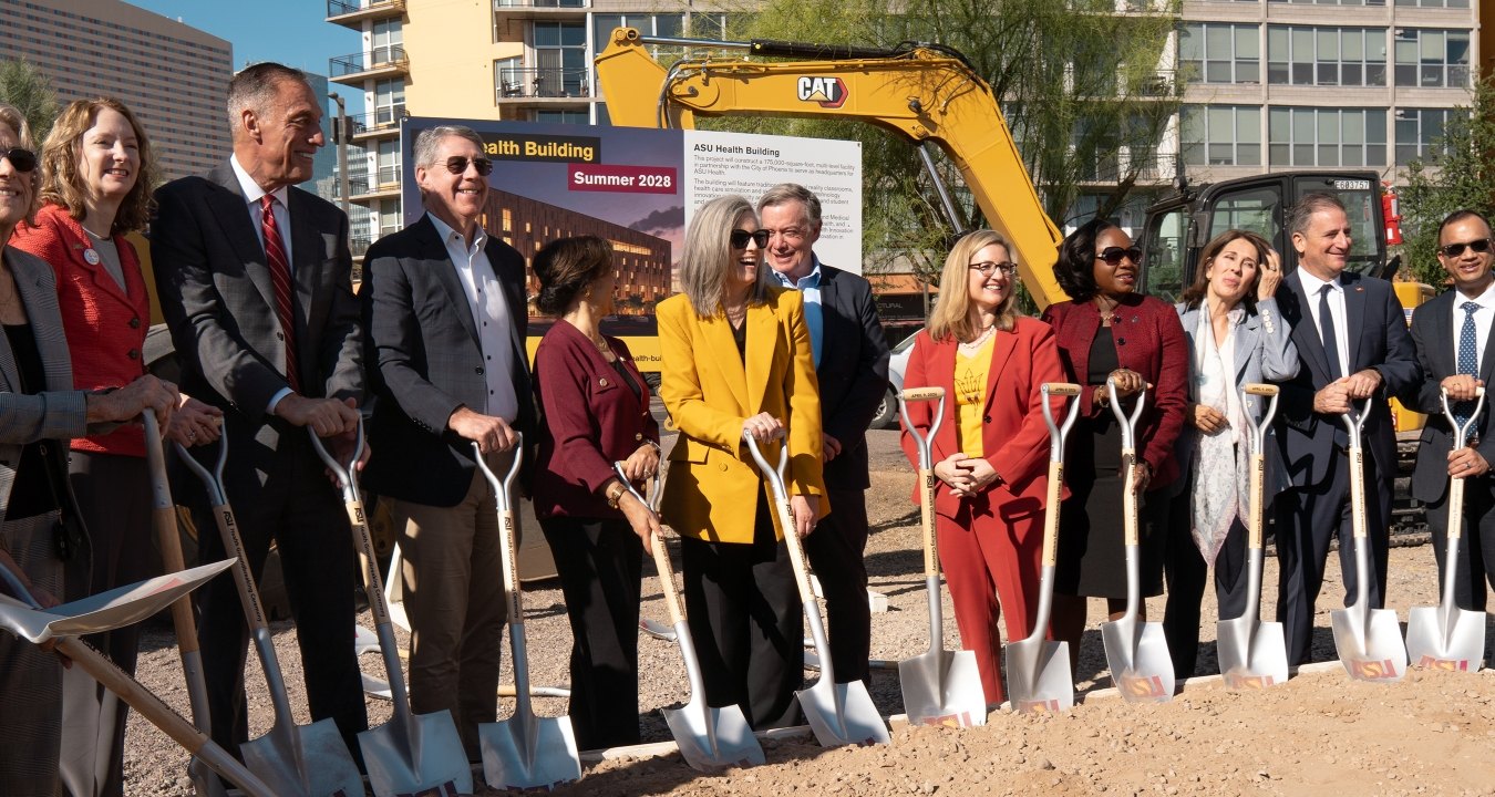 A group of people standing with ceremonial shovels