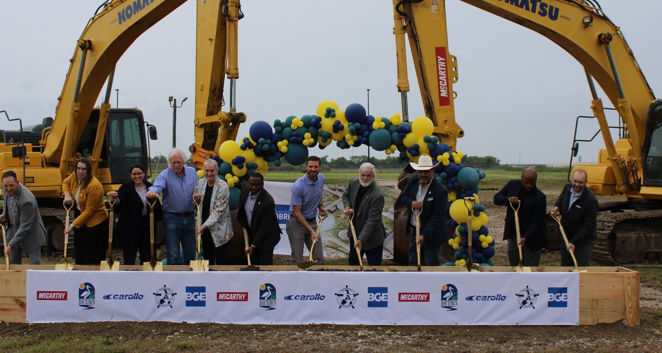 A group of people with shovels celebrating a groundbreaking