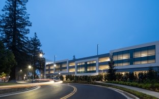 A roadway in front of a building at night