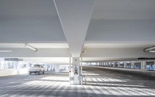 Alternate view of parking spaces inside the parking garage during the daytime.