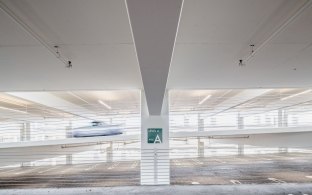 A car driving inside the parking garage. 