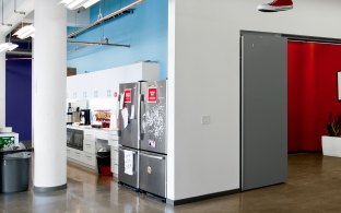 A kitchen area inside of an office space. 