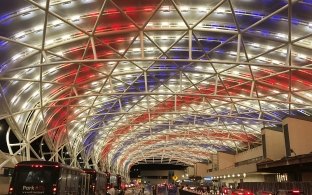 Hartsfield-Jackson Atlanta International Airport: Canopy Lit Up in Red White & Blue; Cars and Busses in Airport Traffic Lanes