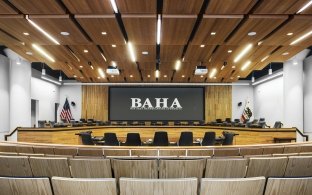 Large auditorium style conference room with a screen. 