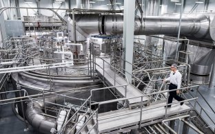 Person walking in industrial facility. 