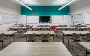 A classroom with tables and chairs