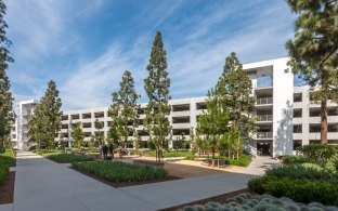 A view of the Hyundai Parking Structure from the tree-lined campus.