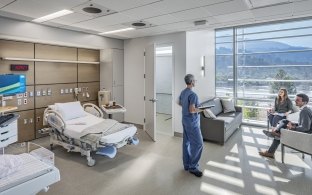 A group of people in a patient room