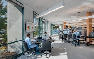 Multiple people working in a lab area.