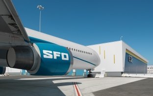 A parked airplane with letters SFO on the engine.