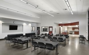 San Joaquin Regional Transit District Operations facility breakroom with chairs, kitchen and TV