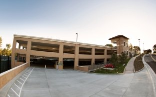 A view of the Soka University of America Parking Structure from the tree-lined campus.