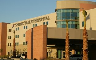 Exterior view of the entryway of the hospital during the daytime.