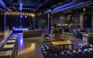 Lounge area with couches and high top bar