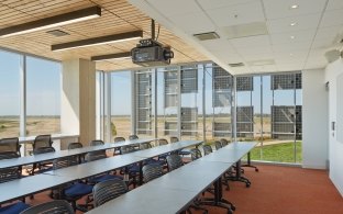 UC Merced Science & Engineering Building Room with Tables, Chairs and Ceiling Video Projector