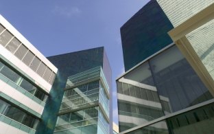 Exterior view of the cancer center standing at the ground level looking up at the building