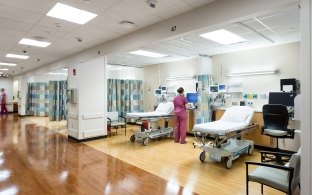 A cancer treatment ward with several empty beds.