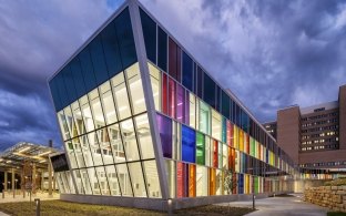 The brightly colored stained glass windows at the VA Hospital at dusk.