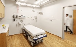 A patient room and bed sit empty.