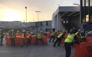 Construction workers moving barricades at LAX